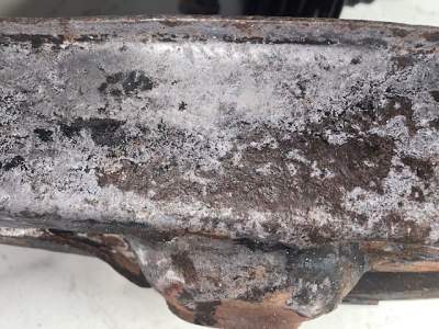 Pho-Kleen B dried on to the steel surface has disolved rust but showing some white powder
